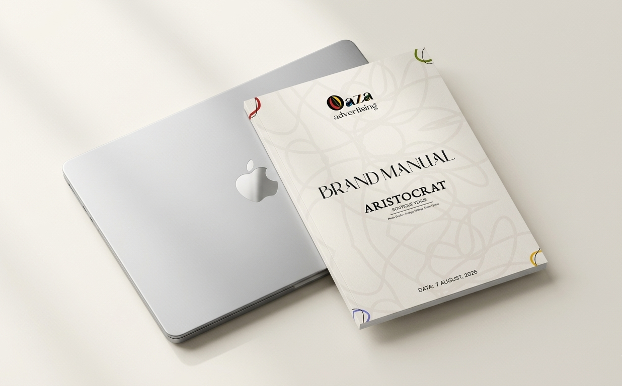 Aristocrat Boutique Venue Brand Manual cover, resting beside a closed laptop